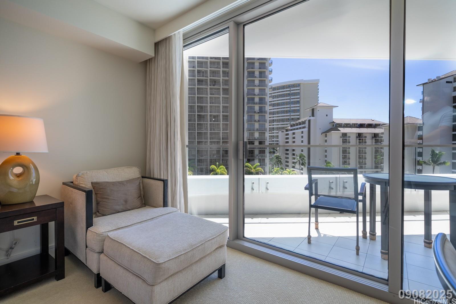 223 Saratoga Road, Unit 918 Honolulu, HI 96815 - Photo 9 of 25 a bedroom with a bed and glass door