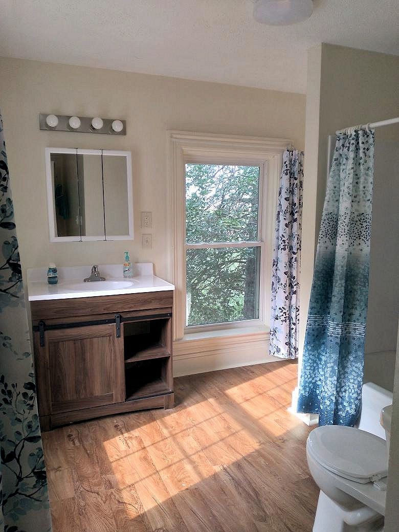 5122 North Bennett Road Monroe Center, IL 61052 - Photo 13 of 29 a spacious bathroom with a double vanity sink toilet and a mirror