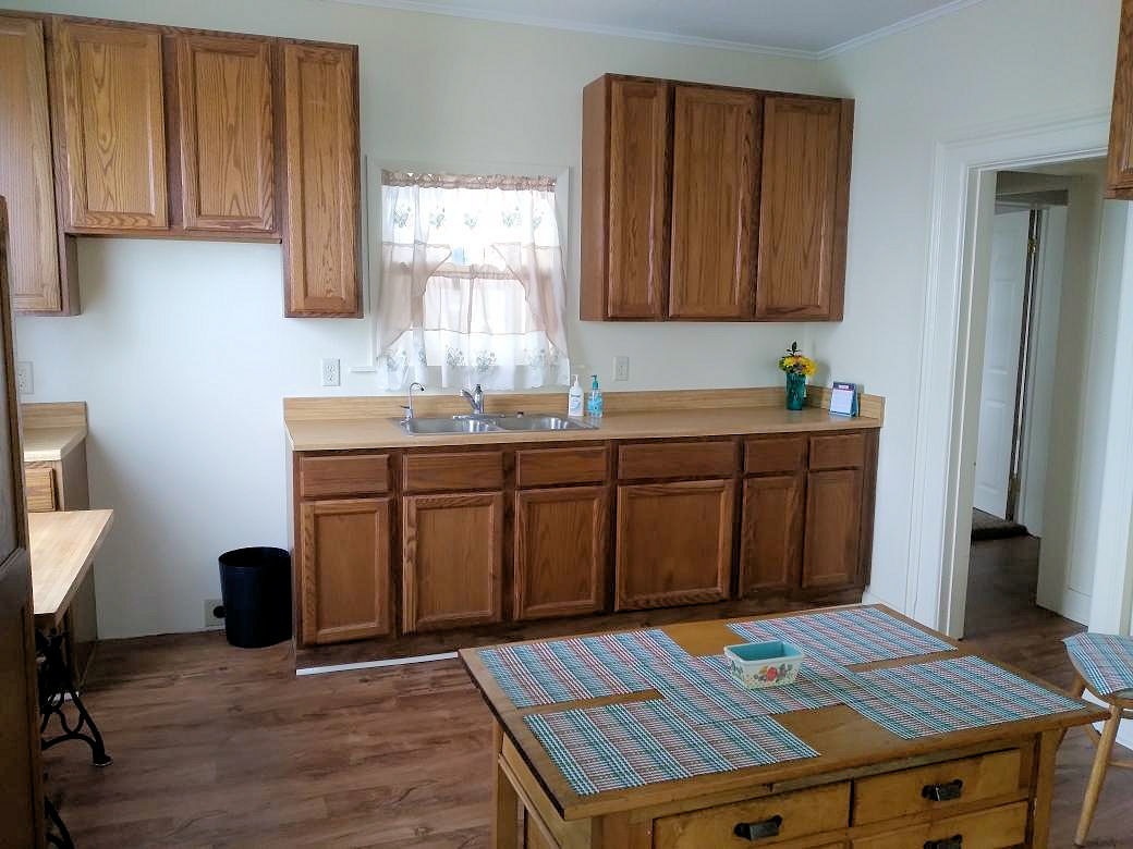 5122 North Bennett Road Monroe Center, IL 61052 - Photo 3 of 29 a kitchen with a sink cabinets and wooden floor