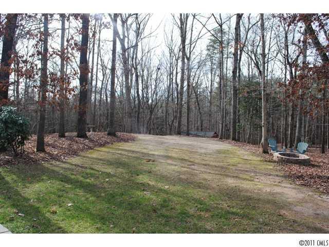 116 Generals Way, Unit 5 Clover, SC 29710 - Photo 14 of 16 a backyard of a house with trees and wooden fence