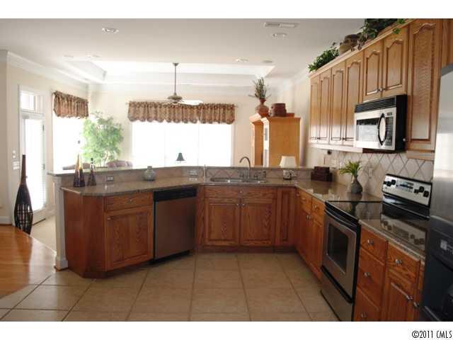 116 Generals Way, Unit 5 Clover, SC 29710 - Photo 6 of 16 a kitchen with stainless steel appliances granite countertop a stove a sink and a microwave