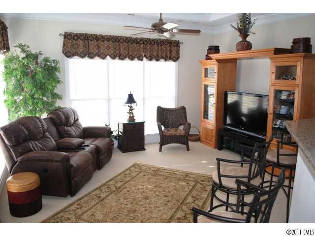 116 Generals Way, Unit 5 Clover, SC 29710 - Photo 7 of 16 a living room with furniture a flat screen tv and a floor to ceiling window