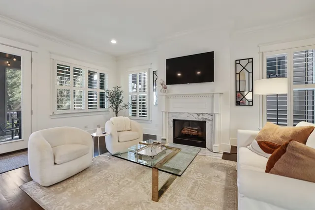 a living room with furniture fireplace and window