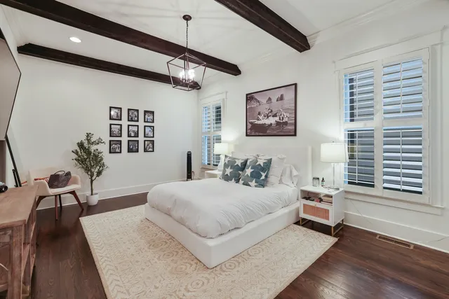 a bedroom with a large bed and a window