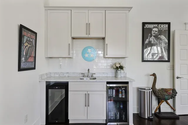 a kitchen with a sink cabinets and wooden floor