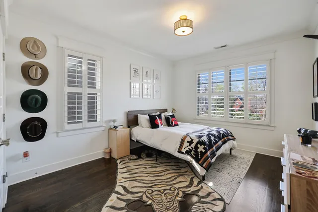 a bed sitting in a bedroom next to a window