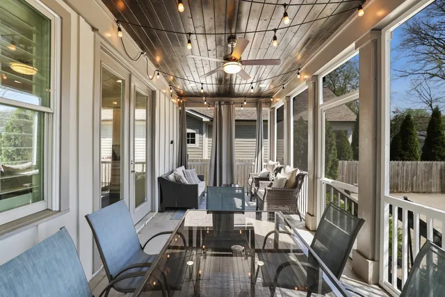 a view of a dining room with furniture large windows and wooden floor