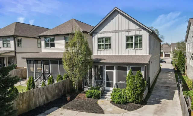 a view of a house with brick walls and flower plants