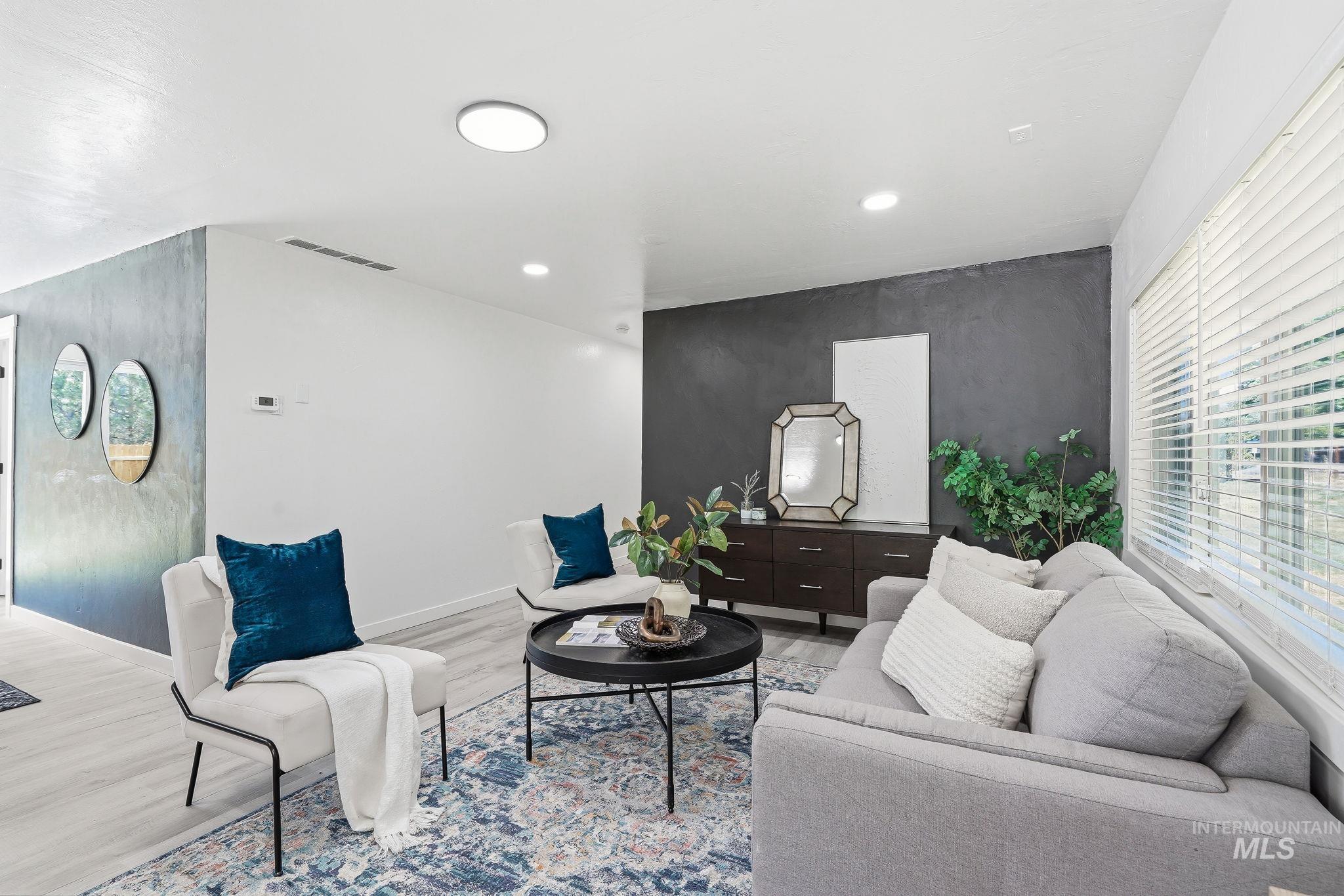 2152 Artesian Road Eagle, ID 83616 - Photo 11 of 50 Spacious living area featuring light wood-finish flooring, recessed lighting, and a window with blinds