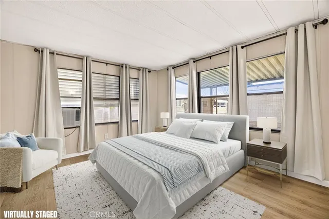 a bedroom with a large bed and a large window