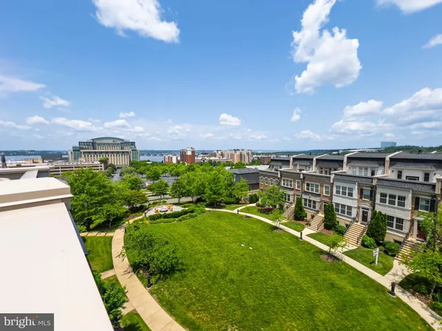 a view of a big yard with swimming pool and lawn chairs