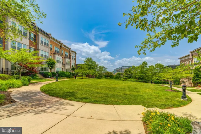 a view of a big building with a big yard and potted plants