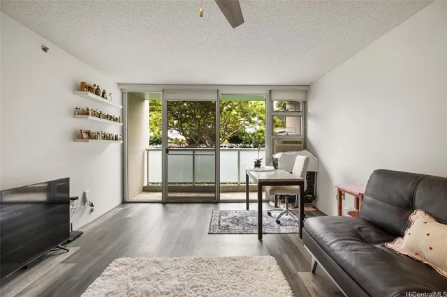 a living room with furniture and a floor to ceiling window