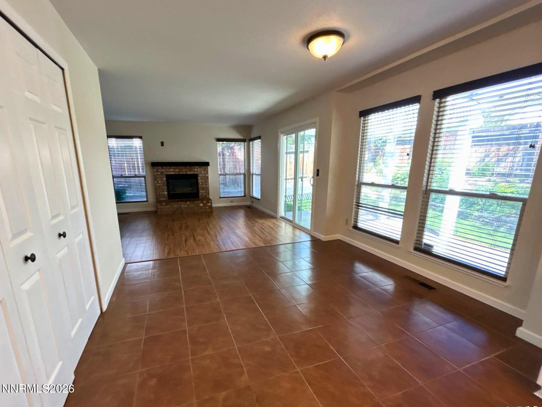 4437 Highplains Drive Reno, NV 89523 - Photo 8 of 19 an empty room with fireplace and windows
