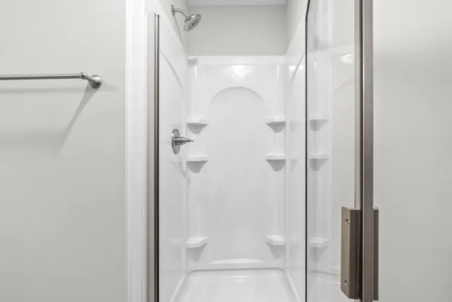 a bathroom with a glass shower door
