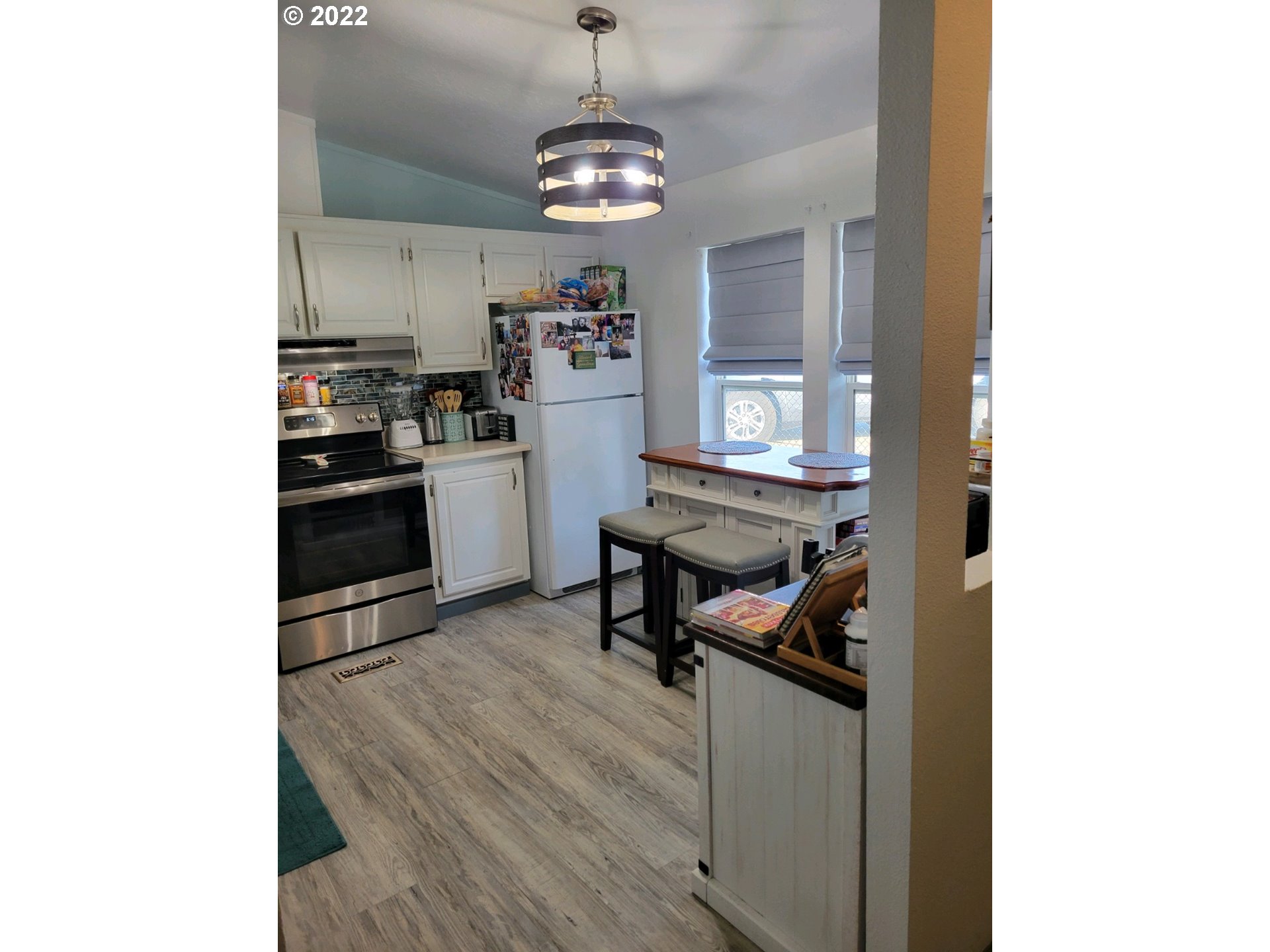 2600 Southwest Goodwin Avenue, Unit 5 Pendleton, OR 97801 - Photo 23 of 31 a kitchen with stainless steel appliances granite countertop a sink dishwasher and a refrigerator with wooden floor