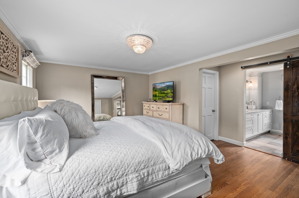 46 Baldpate Road Boxford, MA 01921 - Photo 16 of 42 a spacious bedroom with a bed and a large mirror