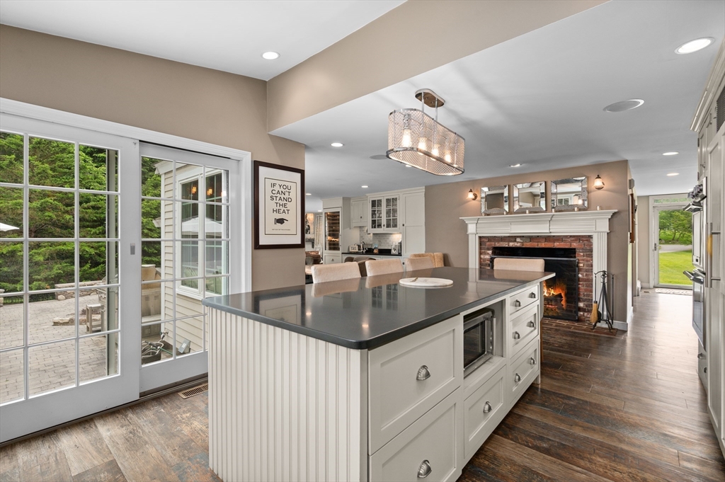 46 Baldpate Road Boxford, MA 01921 - Photo 7 of 42 a kitchen with kitchen island a large counter top space a sink stainless steel appliances and a large window