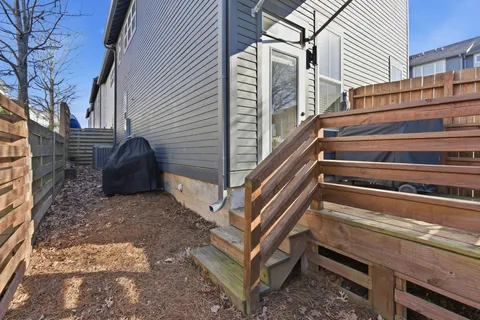 a backyard of a house with wooden stairs