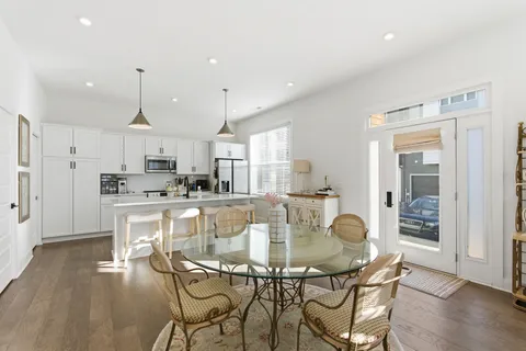 a dining room with kitchen island a table and chairs