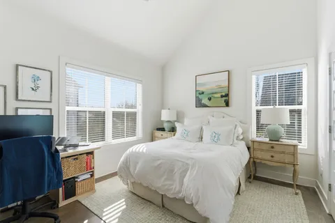 a large bedroom with a bed and glass window