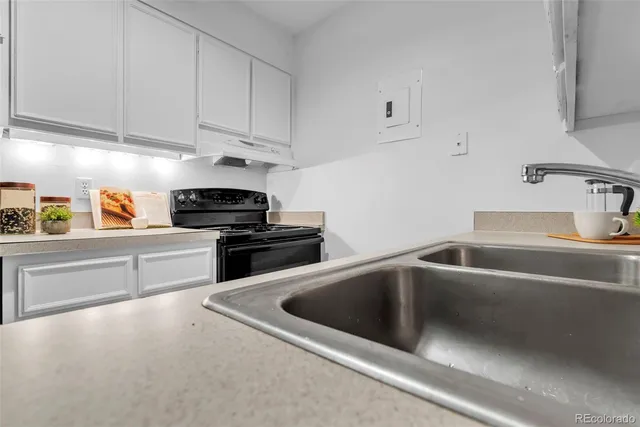 a kitchen that has a sink and cabinets