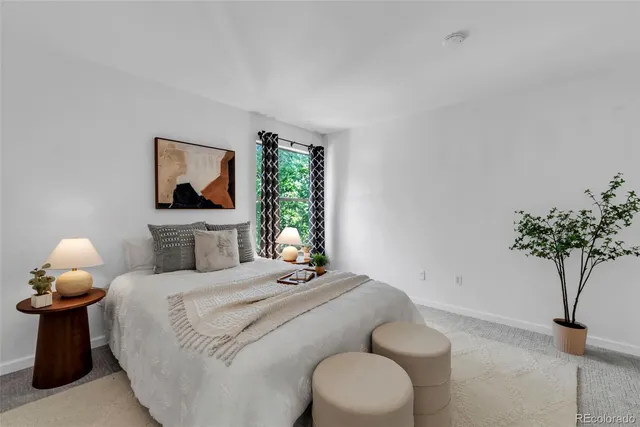 a bedroom with a bed and a potted plant