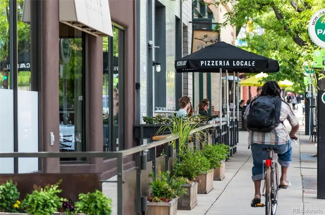 a view of a swimming pool with lawn chairs under an umbrella