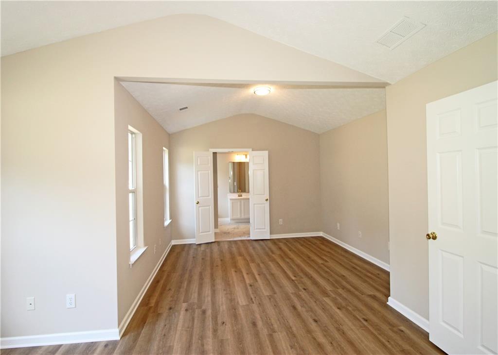 1334 Ambercrest Way Austell, GA 30168 - Photo 12 of 20 a view of a room with wooden floor and brick walls