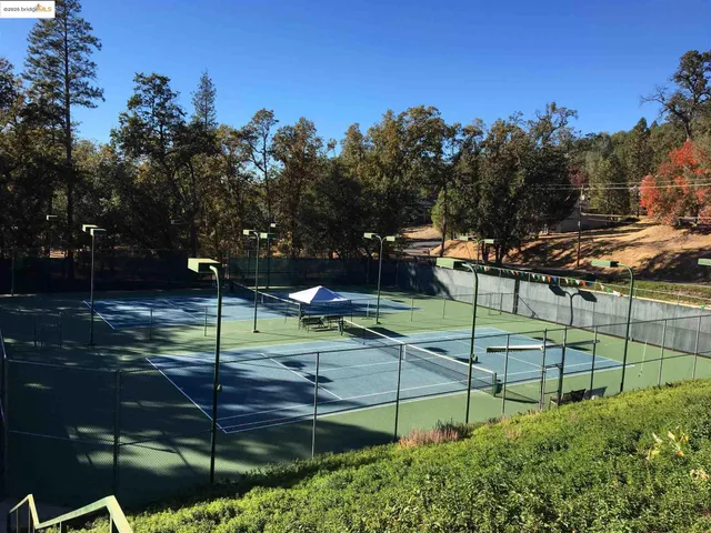a view of swimming pool with a yard and mountain view