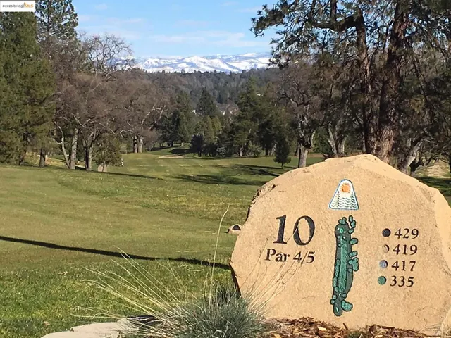 a bathroom with double vanity and a mirror