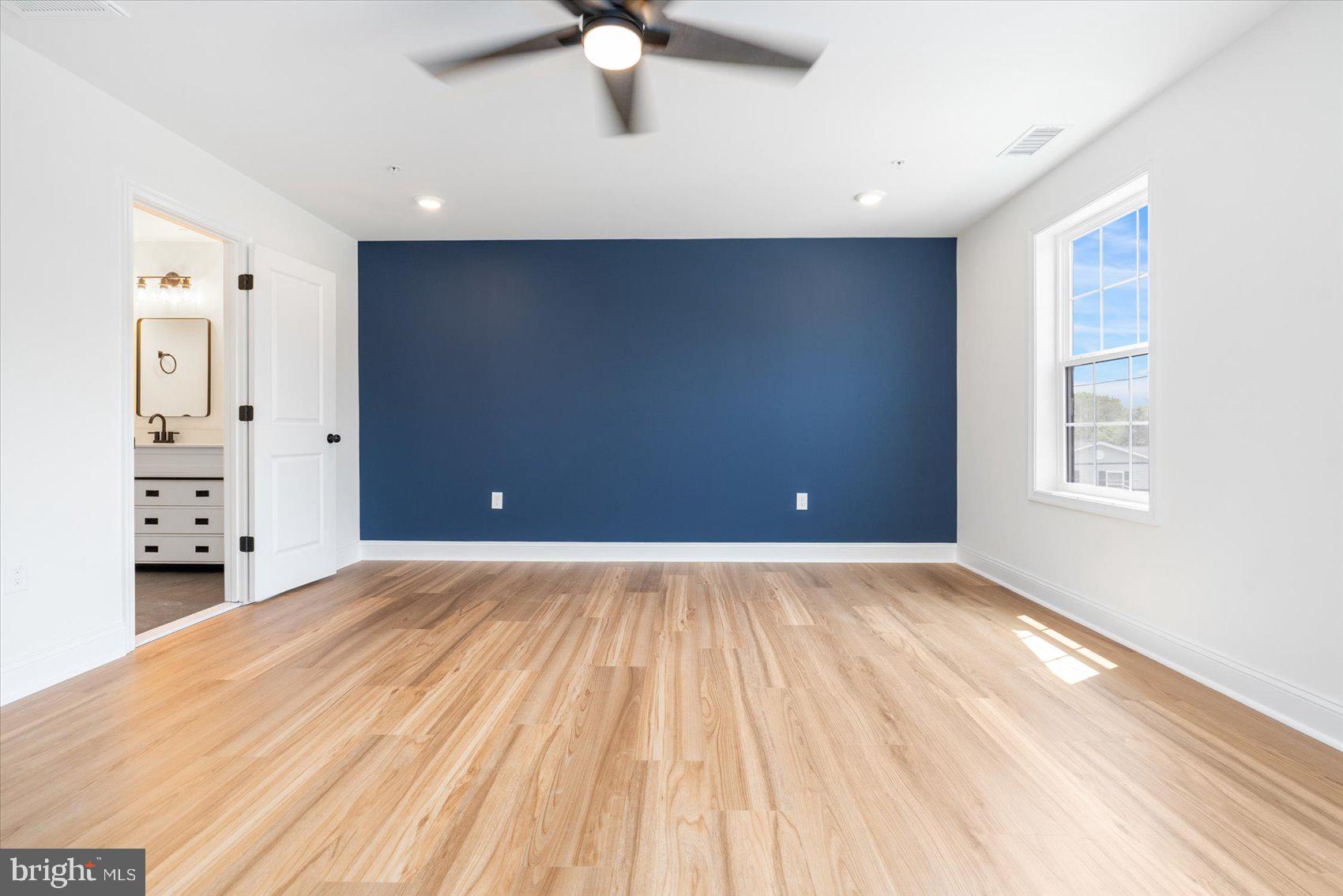 13101 Choptank Avenue Middle River, MD 21220 - Photo 11 of 27 wooden floor in an empty room with a window