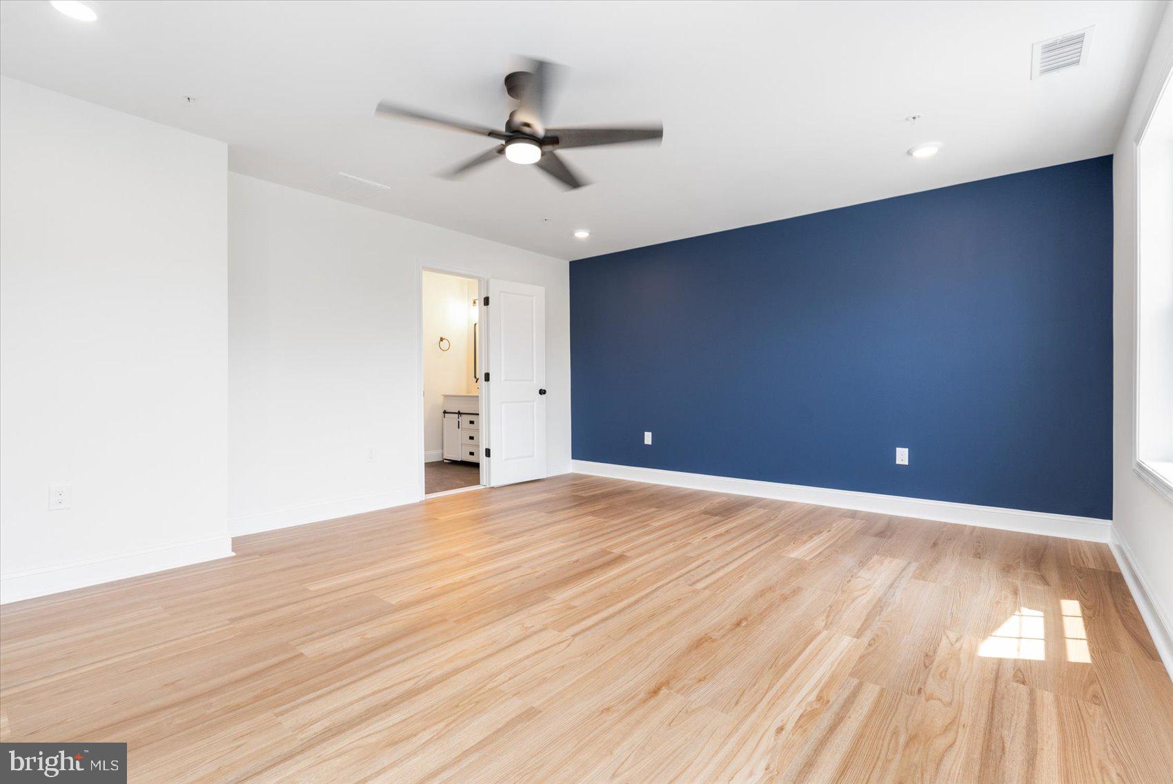 13101 Choptank Avenue Middle River, MD 21220 - Photo 12 of 27 a view of an empty room with wooden floor and a ceiling fan