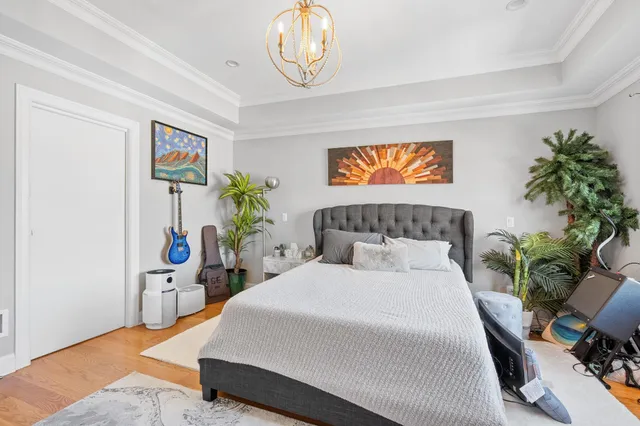 a bedroom with bed and a potted plant