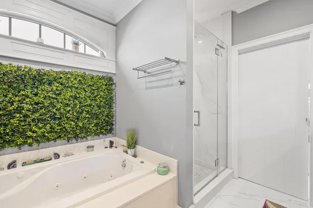 a bathroom with a bathtub and shower