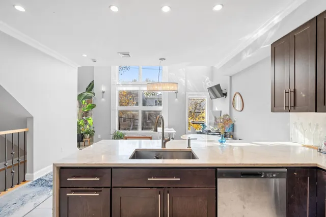 a kitchen with a sink cabinets and window