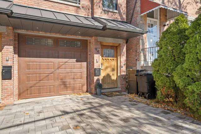 front view of a brick house with a large windows