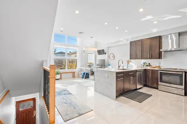 a kitchen with sink a stove and cabinets