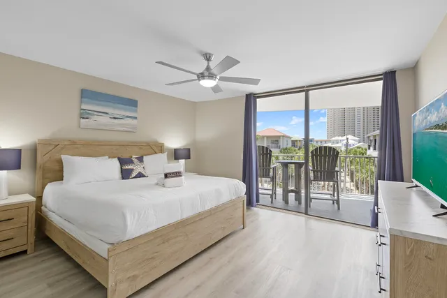 a bedroom with a large bed and a chandelier