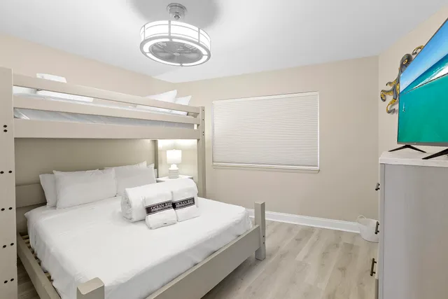 a bedroom with a bed and a chandelier