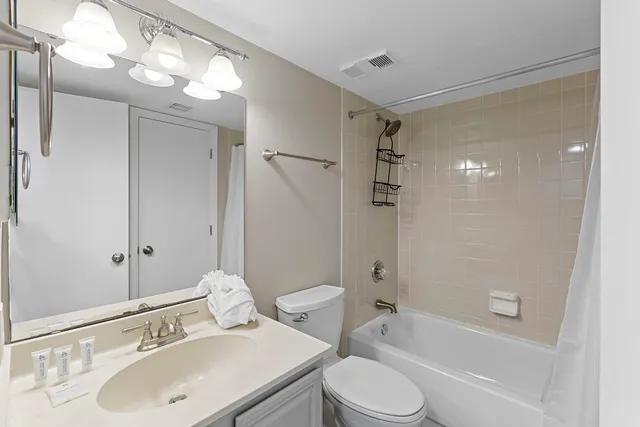 a bathroom with a sink toilet tub and shower