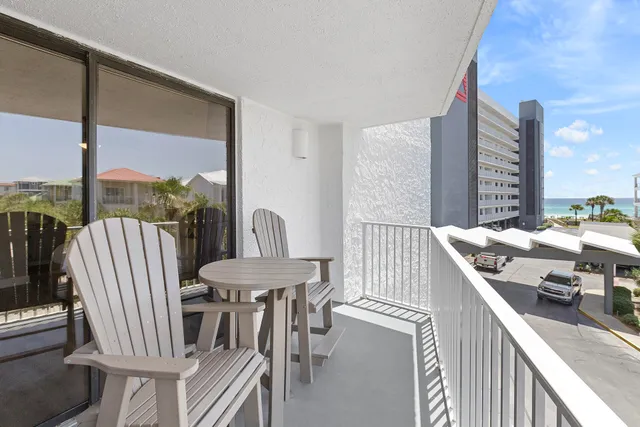 a balcony with table and chairs