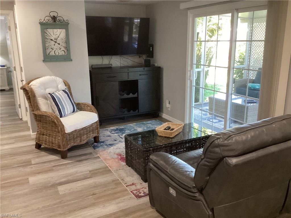 4 Chateau Way Naples, FL 34112 - Photo 14 of 45 a living room with furniture a flat screen tv and a fireplace