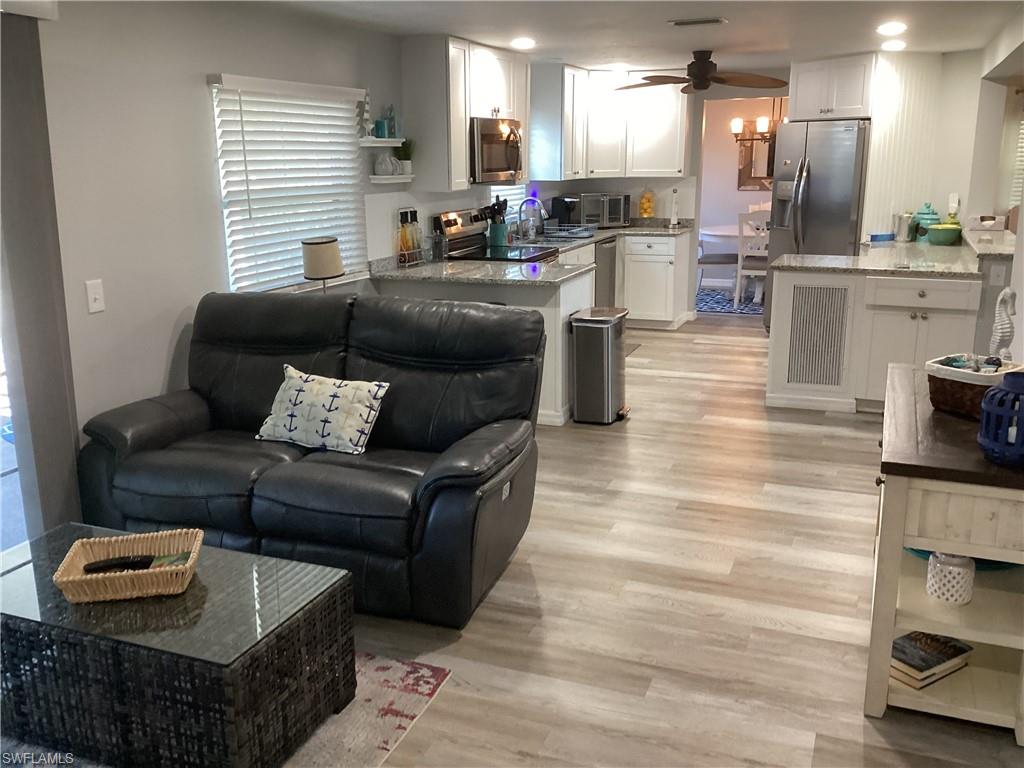 4 Chateau Way Naples, FL 34112 - Photo 15 of 45 a living room with furniture and a wooden floor