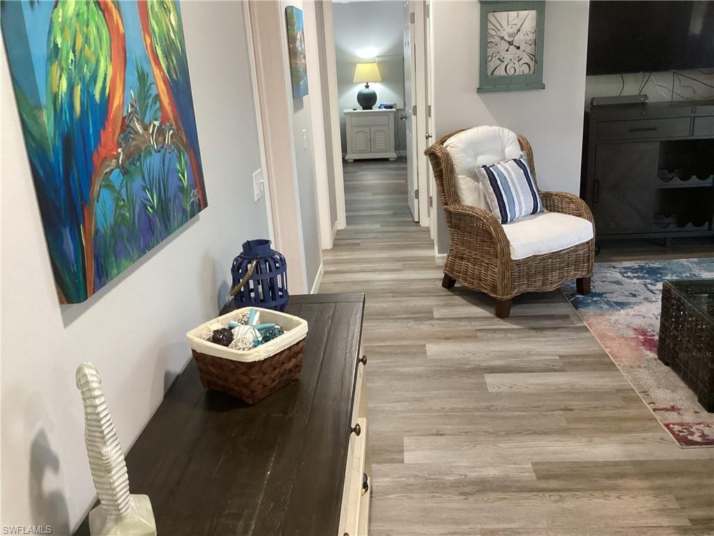 4 Chateau Way Naples, FL 34112 - Photo 16 of 45 a living room with furniture and a wooden floor