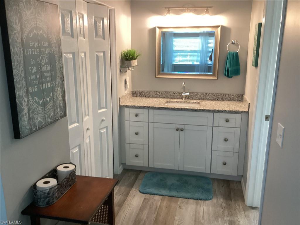 4 Chateau Way Naples, FL 34112 - Photo 19 of 45 a bathroom with a granite countertop sink a mirror and a