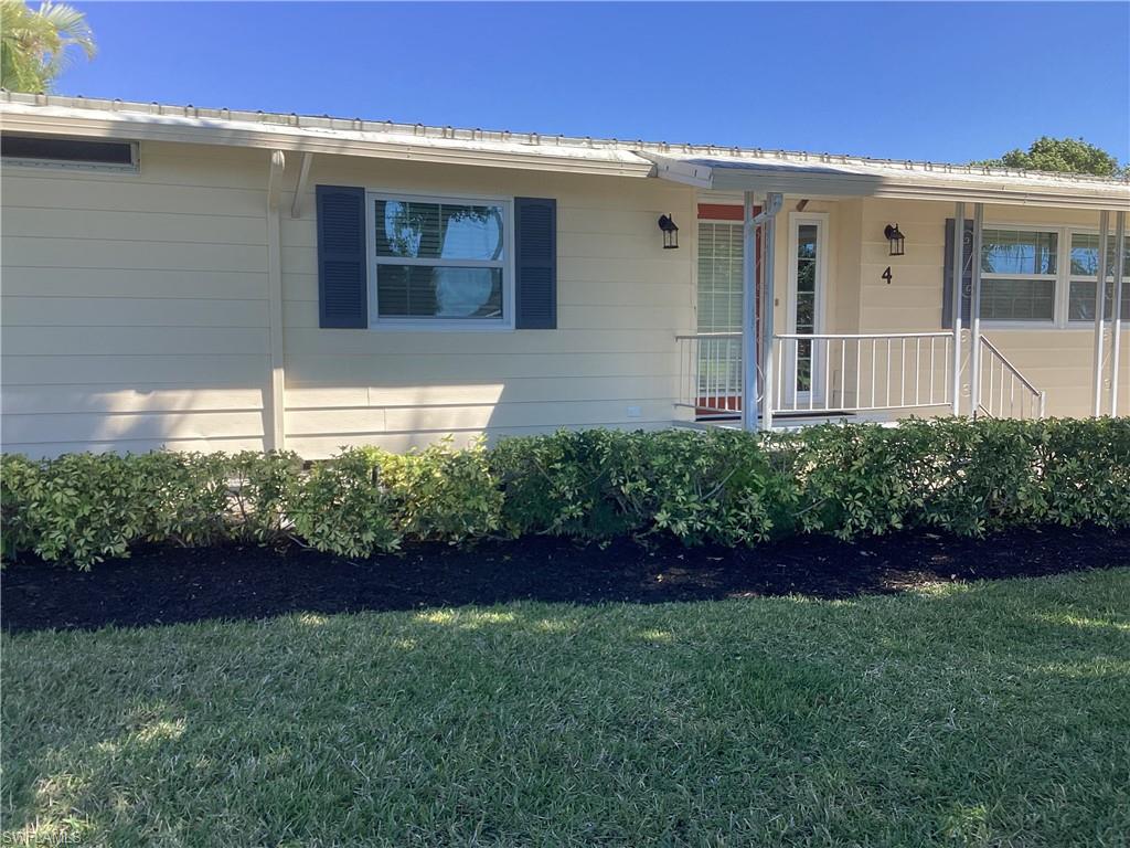 4 Chateau Way Naples, FL 34112 - Photo 2 of 45 a front view of a house with a yard