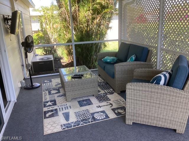 4 Chateau Way Naples, FL 34112 - Photo 27 of 45 a living room with furniture a flat screen tv and a fireplace