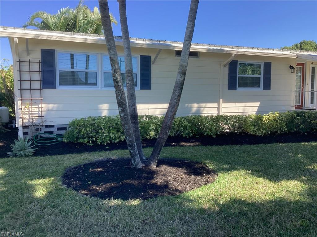 4 Chateau Way Naples, FL 34112 - Photo 3 of 45 a front view of a house with garden