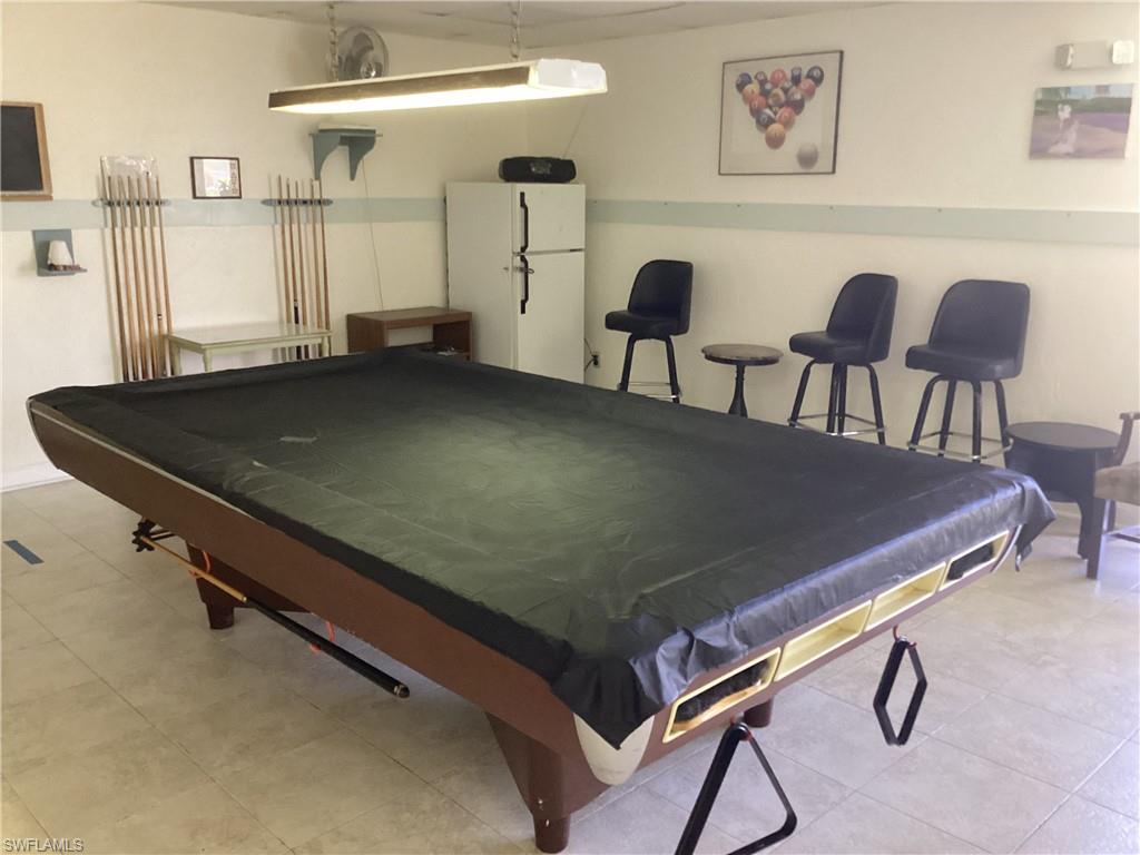 4 Chateau Way Naples, FL 34112 - Photo 40 of 45 a living room with a table